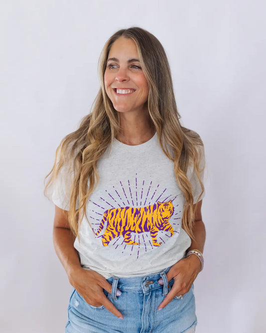 Woman wearing a white t-shirt with a colorful graphic design of a tiger on a plain background. available at ShopTukTuk.com