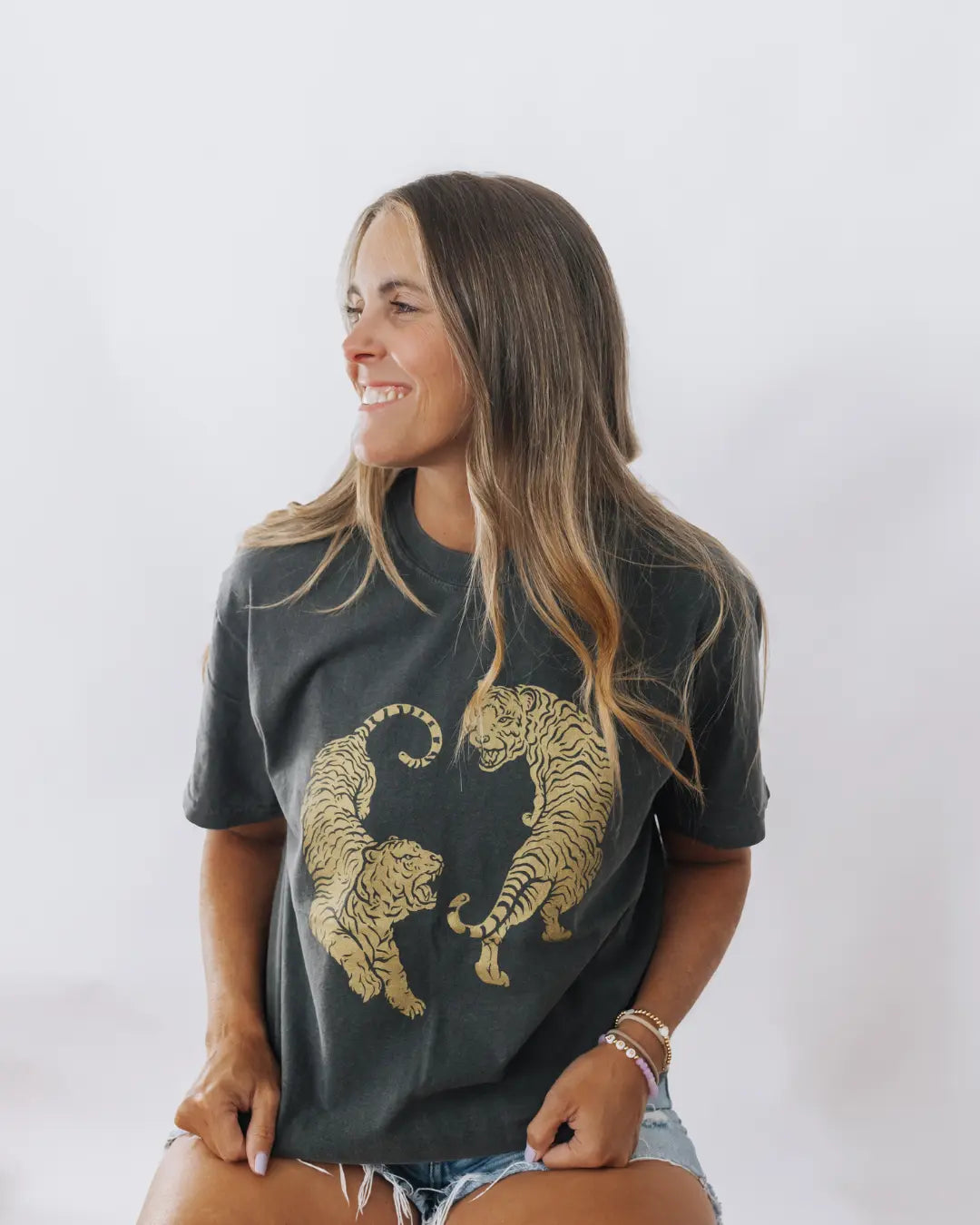 Woman wearing a charcoal tshirt featuring two golden tigers at ShopTukTuk.com