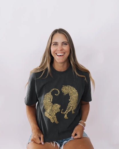 Woman wearing a charcoal tshirt with two golden tigers from Tuk Tuk Trading