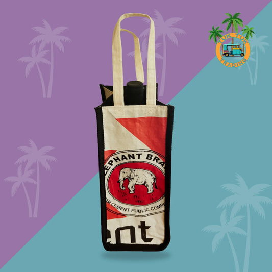Tote bag with a red and white label featuring an elephant and text on a purple and blue gradient background with palm tree silhouettes from Tuk Tuk Trading