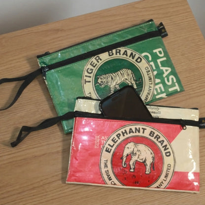 Two wristlets with vintage brand logos on a wooden surface available at ShopTukTuk.com